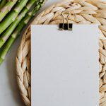 Asparagus and blank paper on a mat